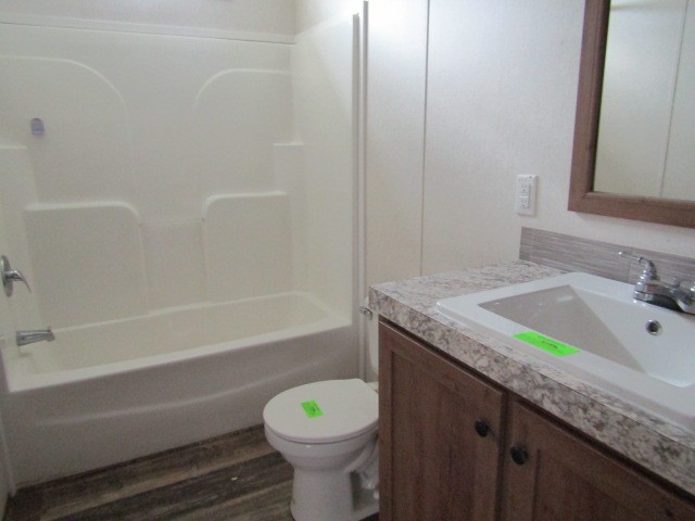 9578 Sunrise Road Red Boiling Springs, TN 37150 - Photo 14 of 19 a bathroom with a granite countertop bathtub sink vanity mirror and toilet