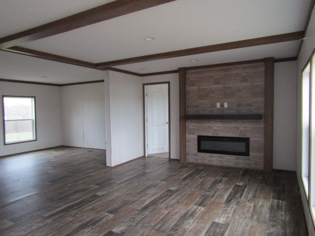 9578 Sunrise Road Red Boiling Springs, TN 37150 - Photo 3 of 19 an empty room with wooden floor a fireplace and windows