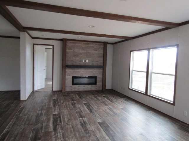 9578 Sunrise Road Red Boiling Springs, TN 37150 - Photo 4 of 19 an empty room with wooden floor fireplace and windows