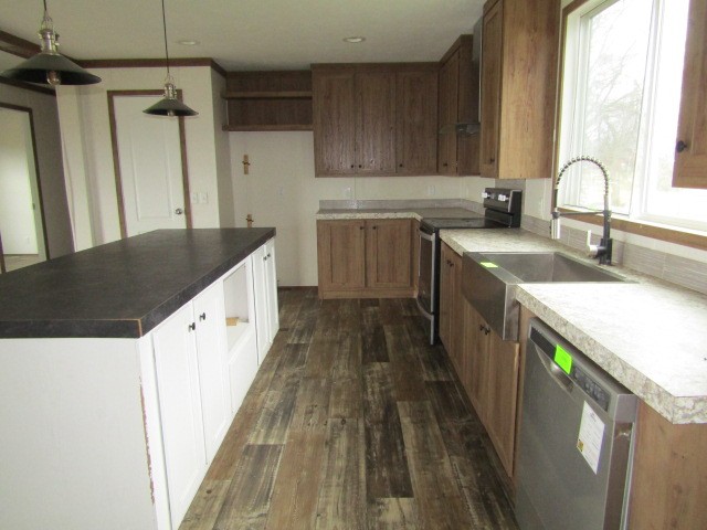 9578 Sunrise Road Red Boiling Springs, TN 37150 - Photo 6 of 19 a kitchen with a sink and wooden cabinets