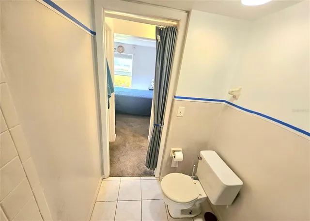 a bathroom with a granite countertop sink mirror vanity and toilet