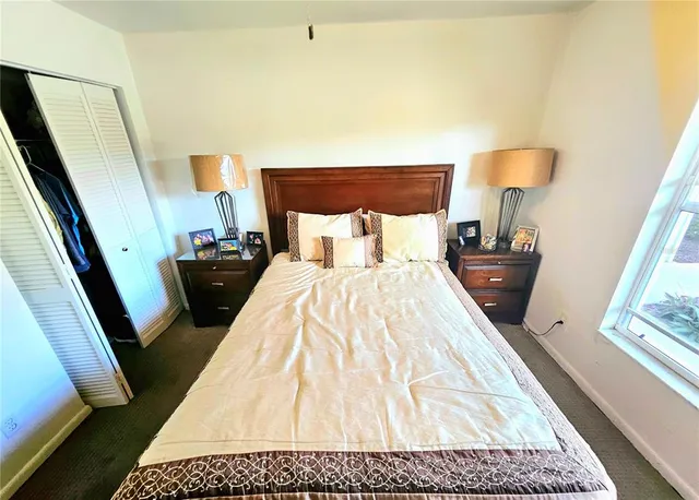 a bed sitting in a bedroom with a mirror