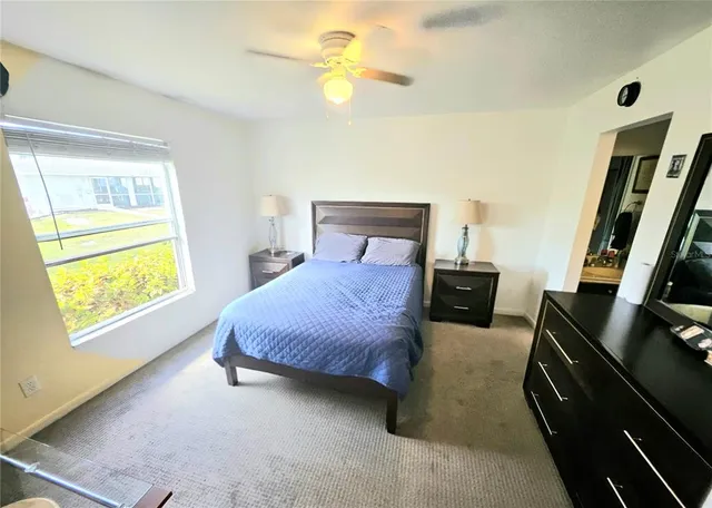 a spacious bedroom with a bed and a chandelier