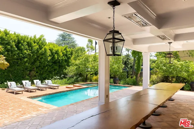 a view of swimming pool with a patio