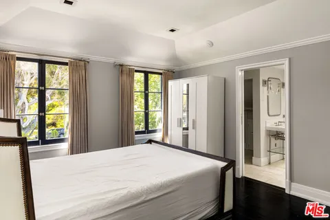 a bedroom with a large bed and a large window