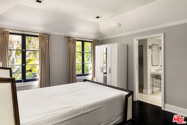 a bedroom with a large bed and a large window