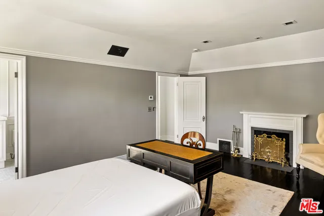 a bedroom with a bed and a fireplace