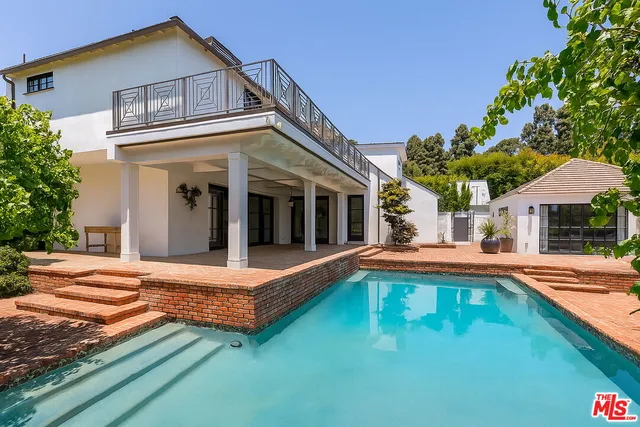 a view of a house with pool and sitting area
