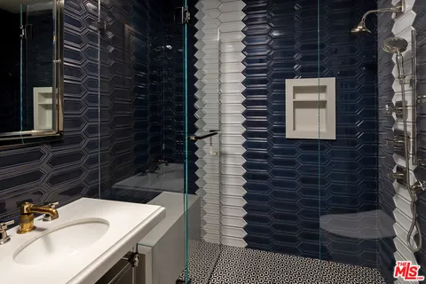 a bathroom with a sink a vanity and a shower