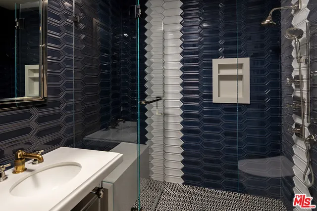 a bathroom with a sink a vanity and a shower