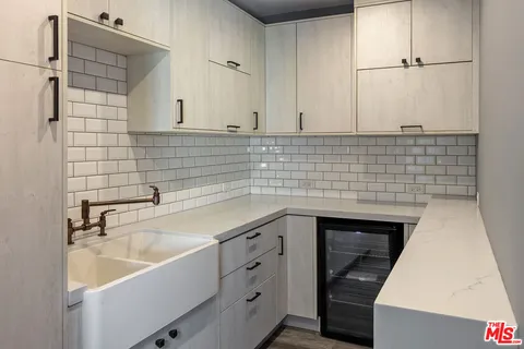 a kitchen with a sink and cabinets