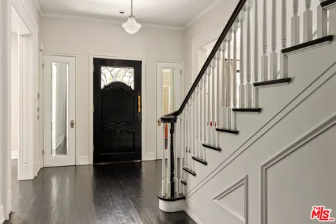 a view of entryway with wooden floor and stairs
