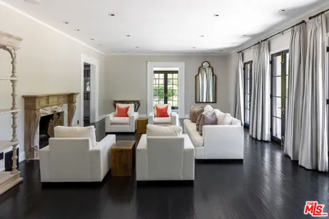 a living room with furniture wooden floor and a fireplace