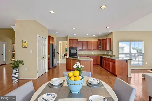 a large kitchen with a table and chairs