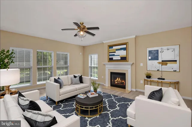 a living room with furniture a fireplace and window