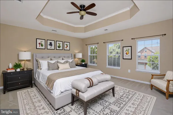 a spacious bedroom with a bed a couch and a window
