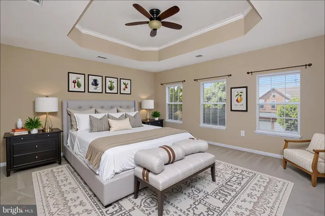 a spacious bedroom with a bed a couch and a window