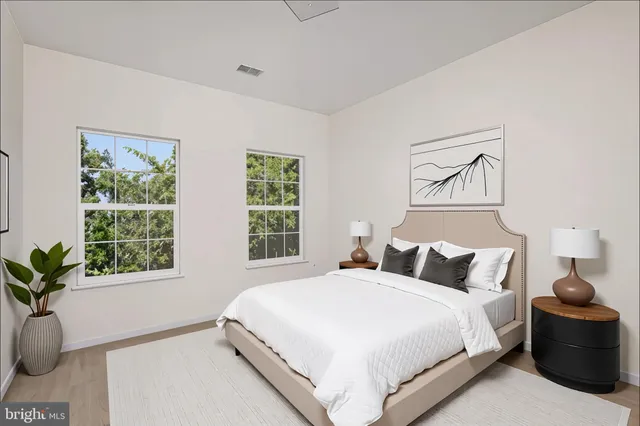a bedroom with a large bed and a window