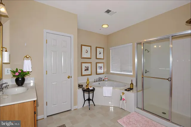 a view of a bathroom with a tub shower and mirror