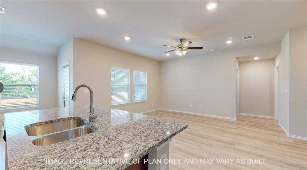 10212 Neptune Court Waco, TX 76708 - Photo 22 of 22 Kitchen with recessed lighting, light wood-style flooring, light stone counters, ceiling fan, and open floor plan