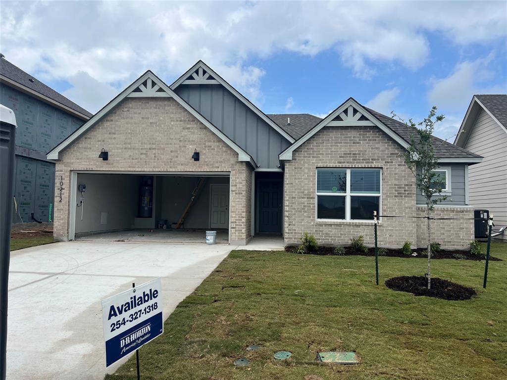 10212 Neptune Court Waco, TX 76708 - Photo 2 of 22 Craftsman-style home featuring an attached garage, driveway, a front yard, board and batten siding, and brick siding Digital R