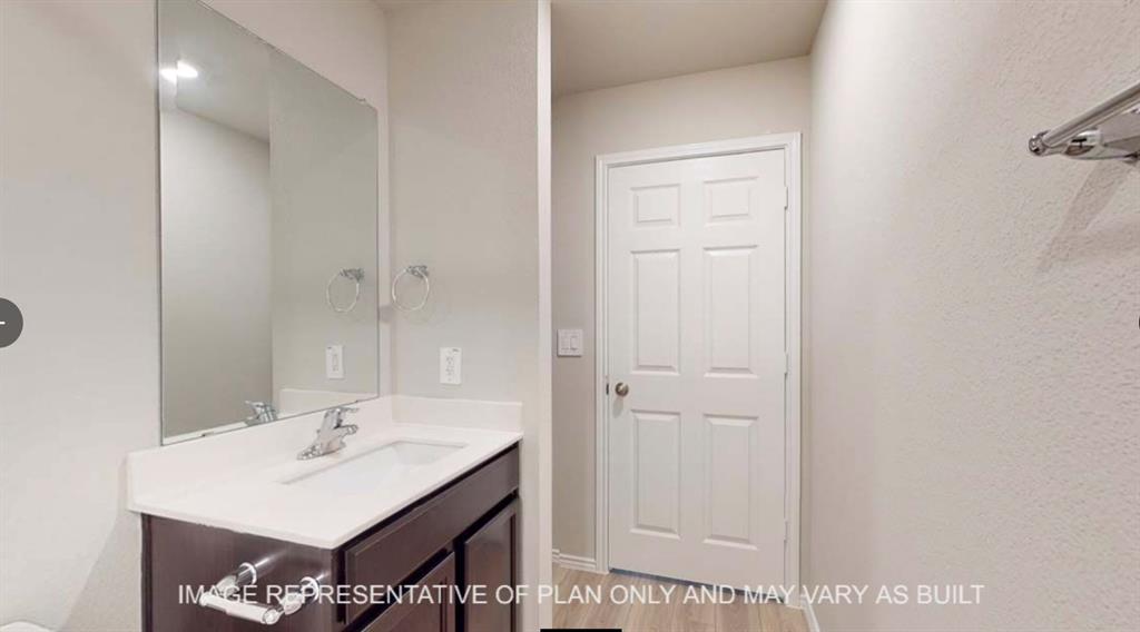 10212 Neptune Court Waco, TX 76708 - Photo 18 of 22 Bathroom featuring vanity and light wood finished floors