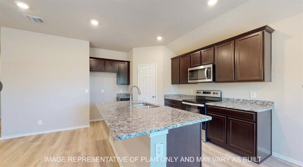 10212 Neptune Court Waco, TX 76708 - Photo 6 of 22 Kitchen with dark wood finish cabinets, stainless steel appliances, light wood finished floors, light stone countertops, and recessed lighting