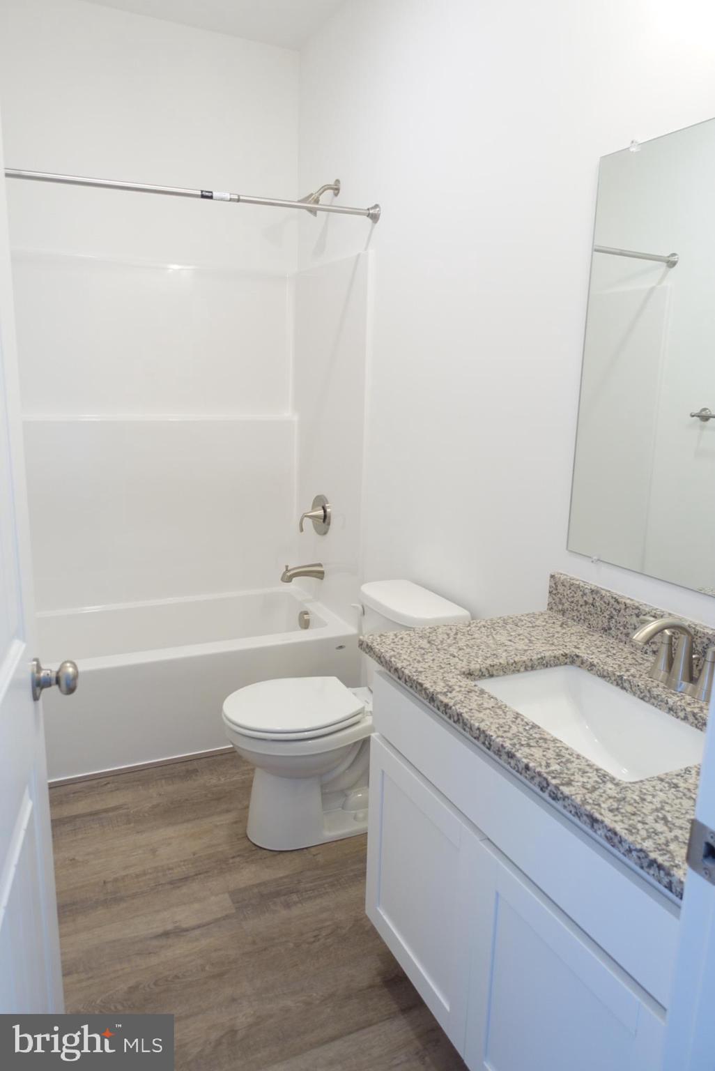 201 Kinneman Road, Unit 25 Abbottstown, PA 17301 - Photo 11 of 32 a bathroom with a granite countertop sink toilet and shower