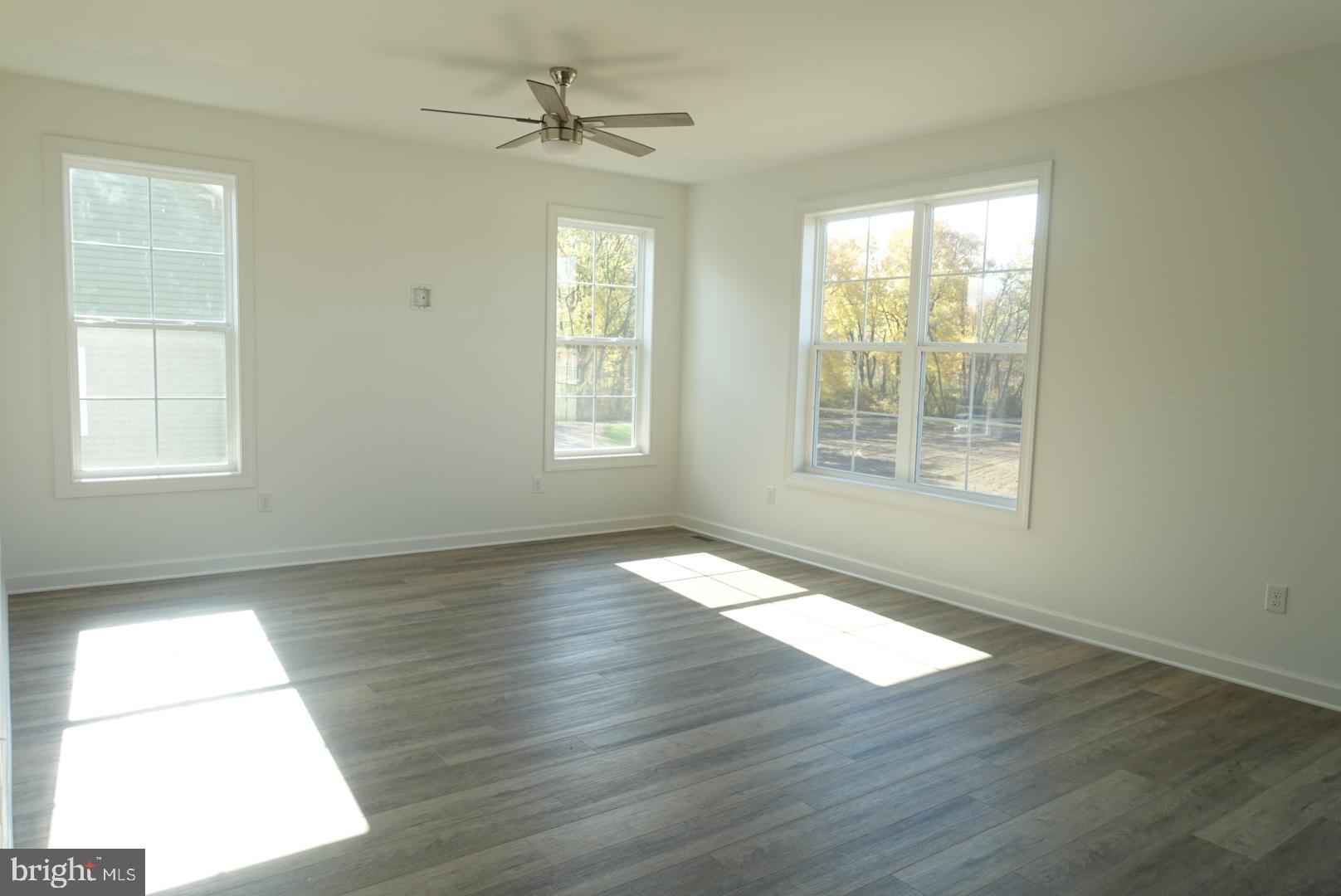 201 Kinneman Road, Unit 25 Abbottstown, PA 17301 - Photo 13 of 32 a view of an empty room with wooden floor and a window