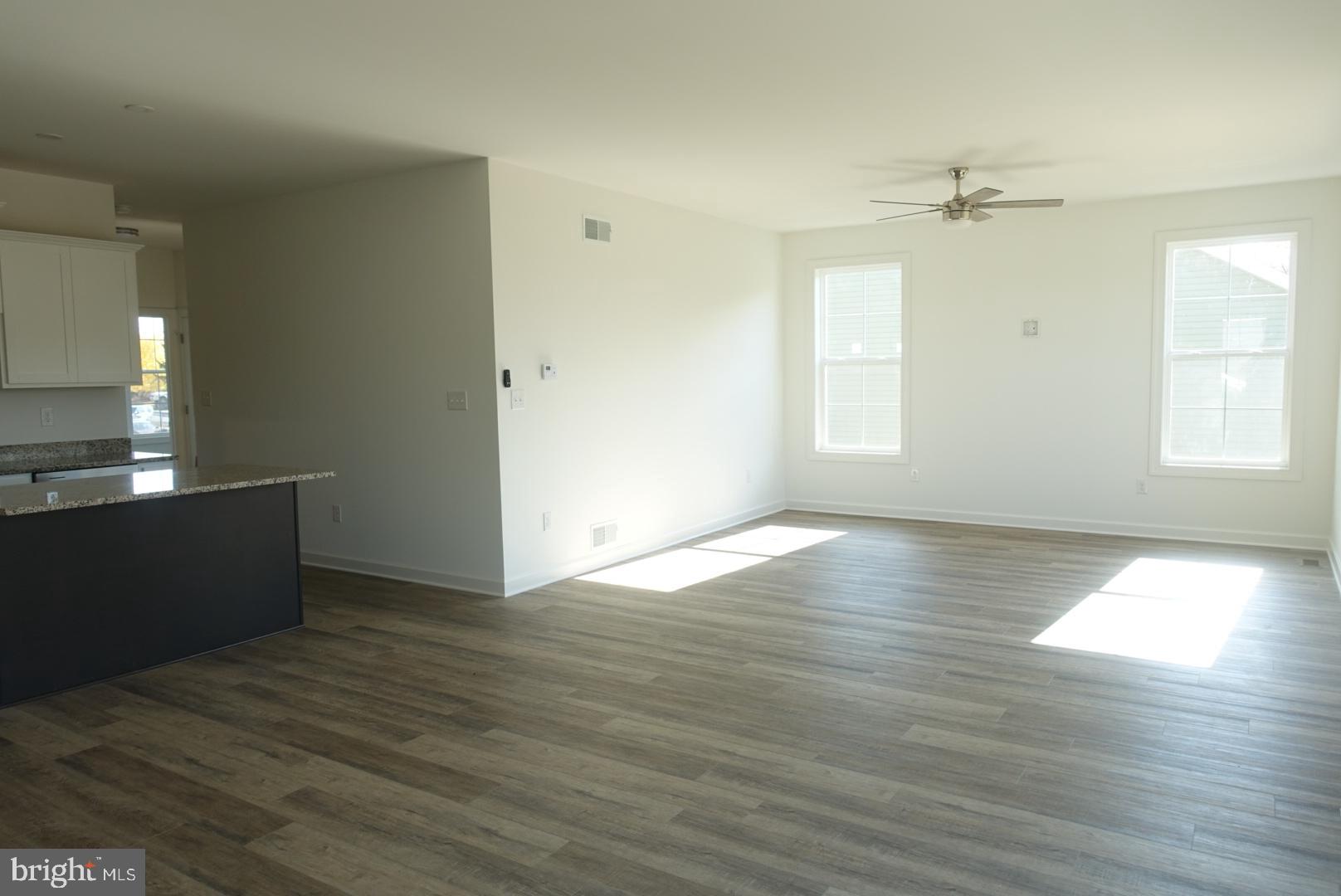 201 Kinneman Road, Unit 25 Abbottstown, PA 17301 - Photo 16 of 32 an empty room with wooden floor and windows