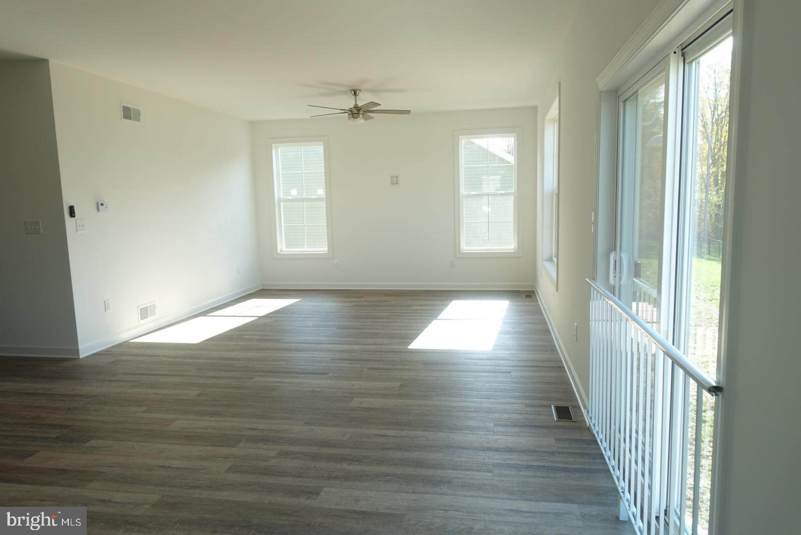 201 Kinneman Road, Unit 25 Abbottstown, PA 17301 - Photo 17 of 32 a view of an empty room with wooden floor and a window