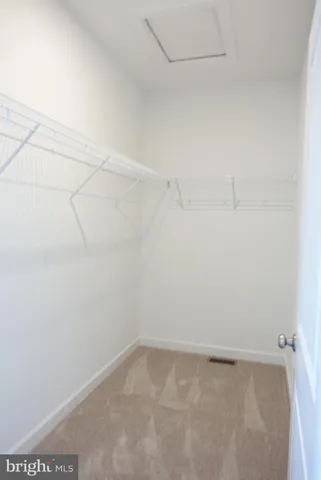 an empty room with a fan and a fan