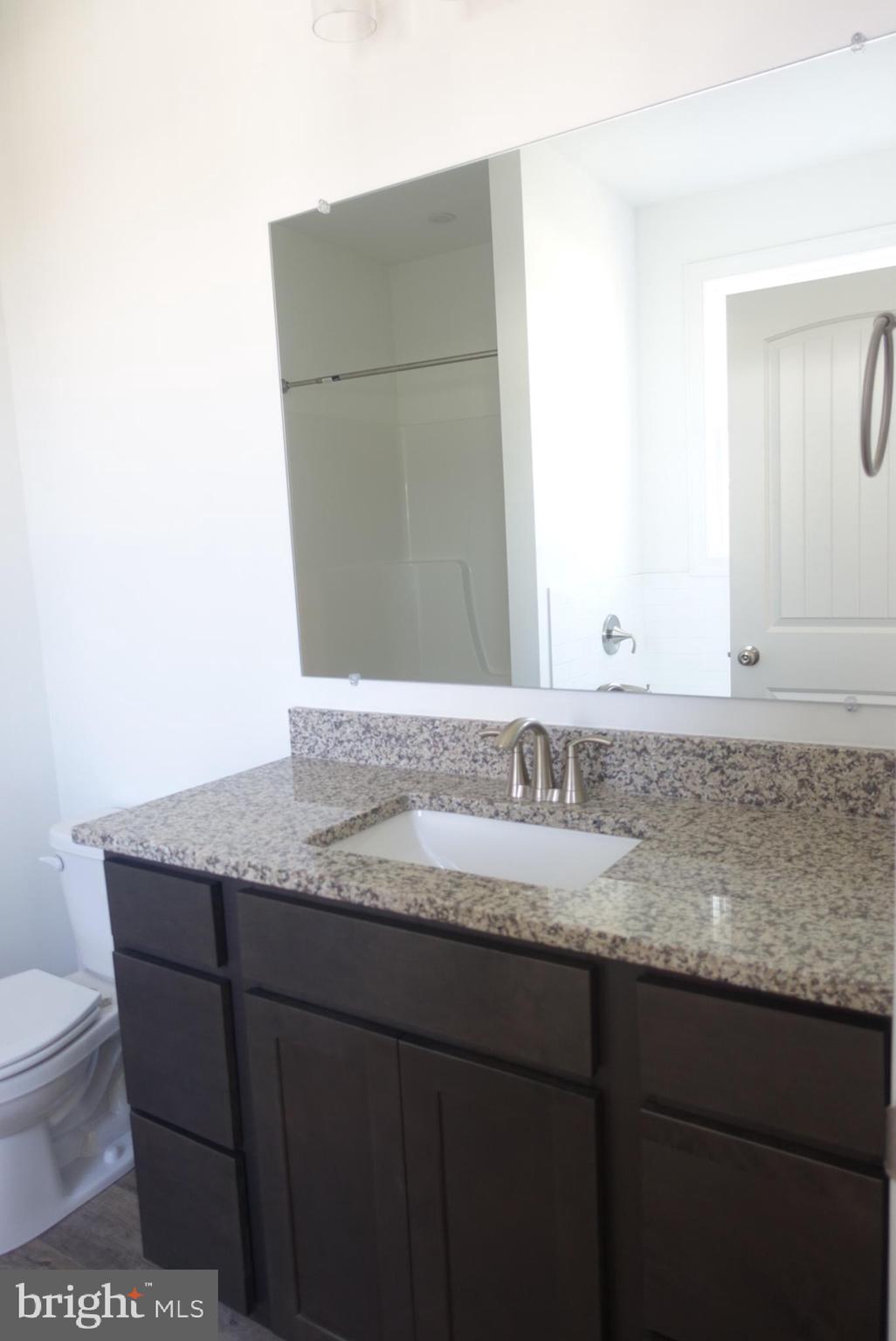 201 Kinneman Road, Unit 25 Abbottstown, PA 17301 - Photo 21 of 32 a bathroom with a granite countertop sink and a mirror