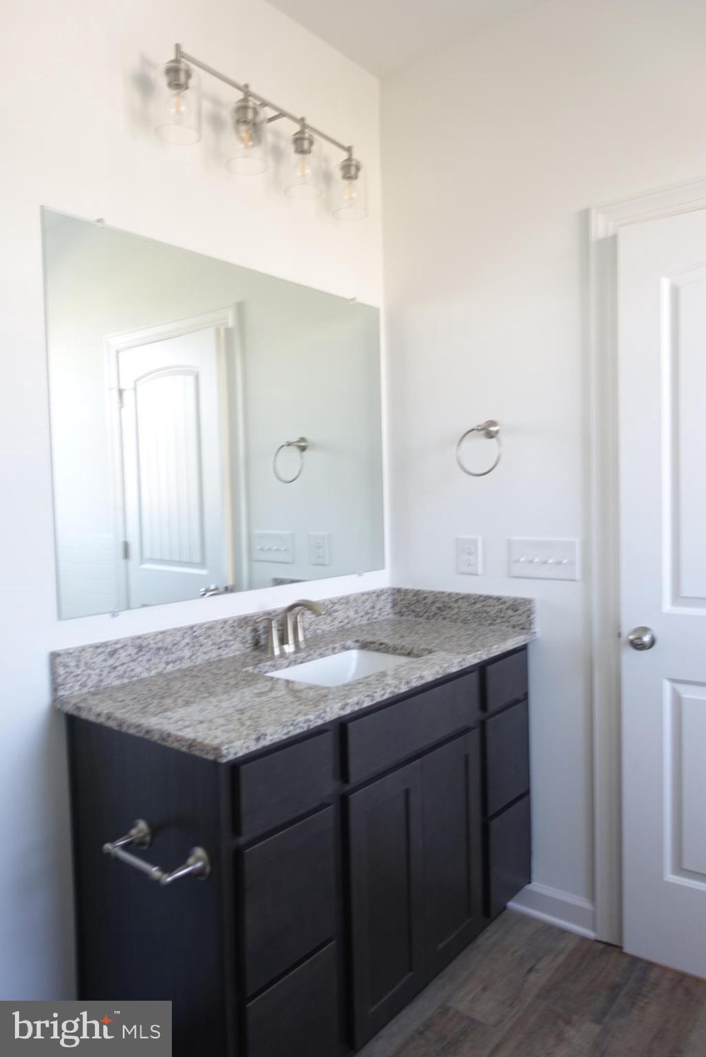 201 Kinneman Road, Unit 25 Abbottstown, PA 17301 - Photo 23 of 32 a bathroom with a granite countertop sink and a mirror