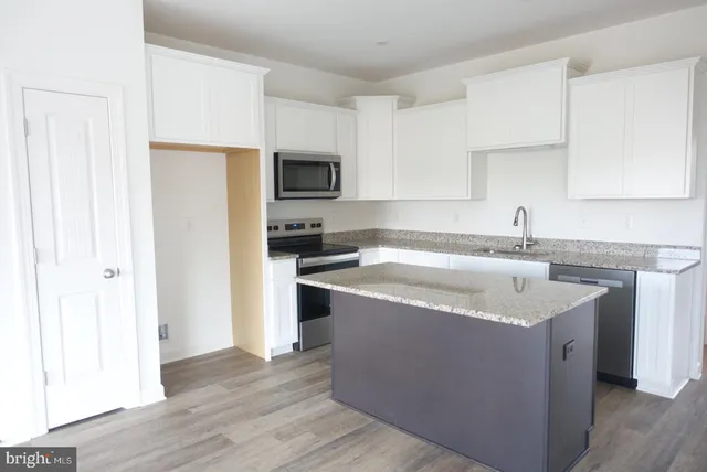 a kitchen with a sink a stove and a refrigerator