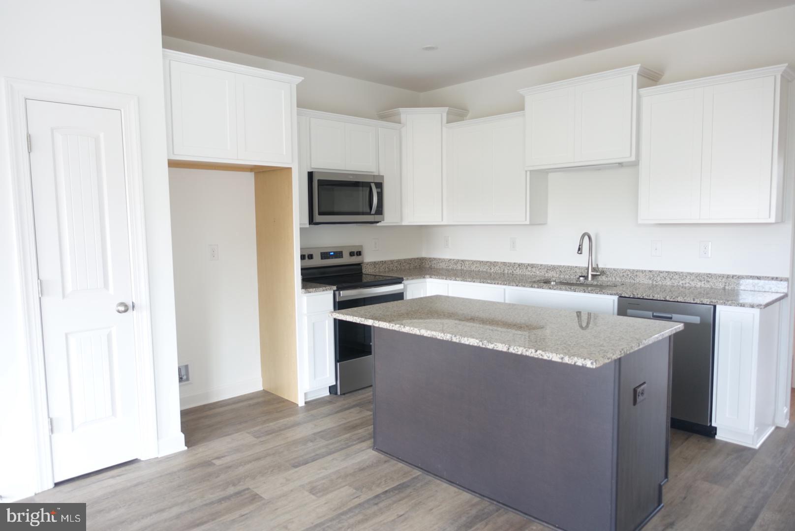 201 Kinneman Road, Unit 25 Abbottstown, PA 17301 - Photo 6 of 32 a kitchen with a sink a stove and a refrigerator