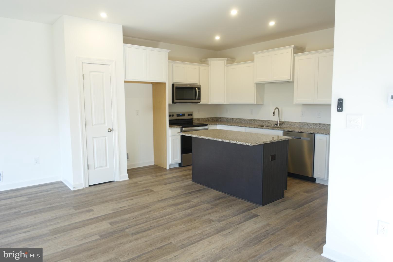 201 Kinneman Road, Unit 25 Abbottstown, PA 17301 - Photo 8 of 32 a kitchen with stainless steel appliances granite countertop a sink stove and refrigerator