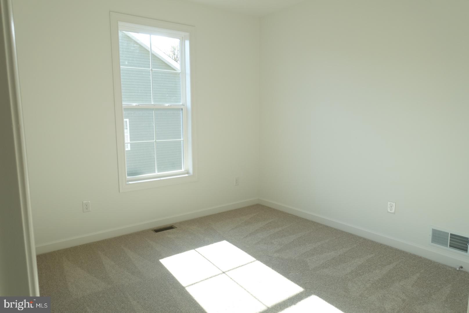 201 Kinneman Road, Unit 25 Abbottstown, PA 17301 - Photo 9 of 32 an empty room with windows