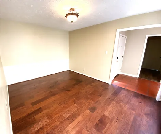 wooden floor in a hall with an empty room