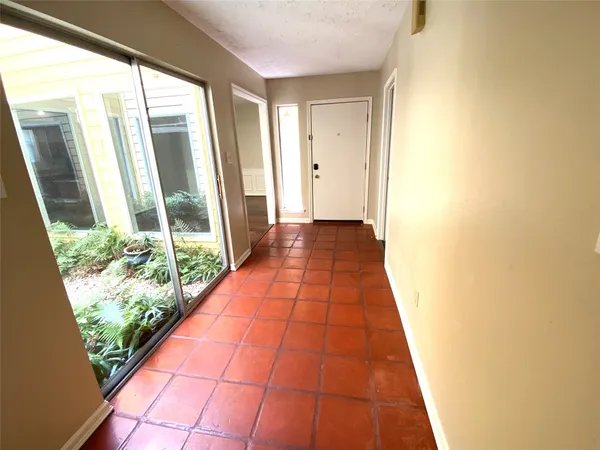 a large kitchen with kitchen island granite countertop wooden cabinets a sink and a stove