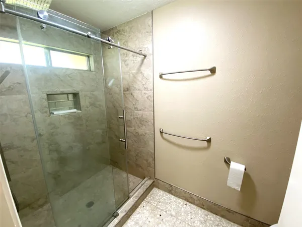 a bathroom with a granite countertop sink toilet and shower