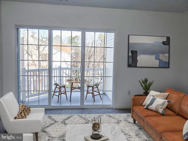 a bedroom that has a bed and a potted plant on the dresser
