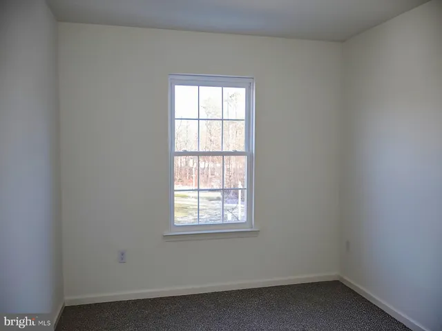 a view of a kitchen with a microwave and cabinets