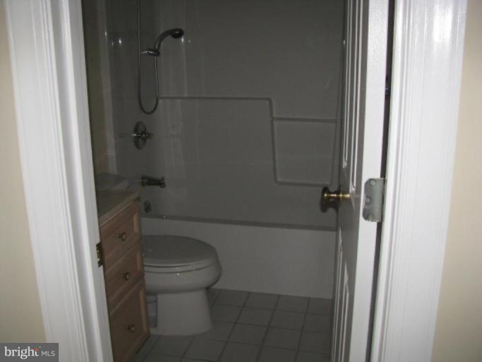 5979 Free State Road Marshall, VA 20115 - Photo 7 of 30 a bathroom with a granite countertop toilet and a shower