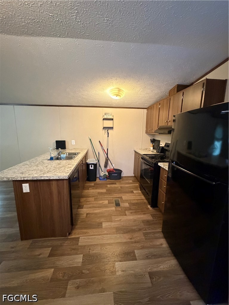 631 Stanton Street Clewiston, FL 33440 - Photo 9 of 24 a kitchen with stainless steel appliances wooden cabinets a sink and a stove