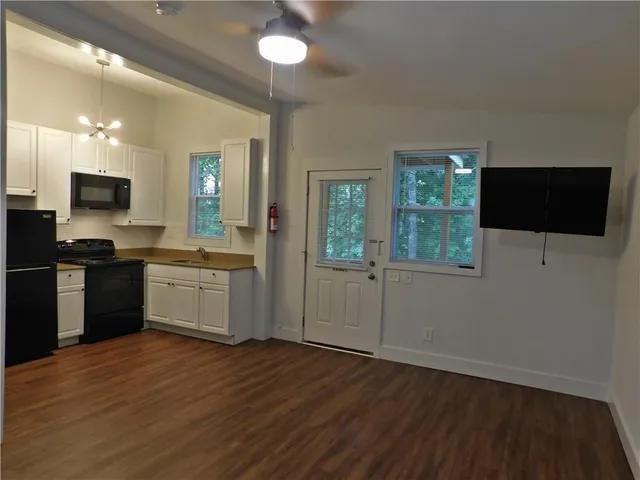 a kitchen with a sink and a stove top oven