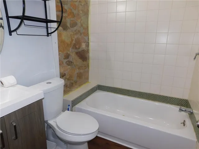 a bathroom with a toilet and a bathtub