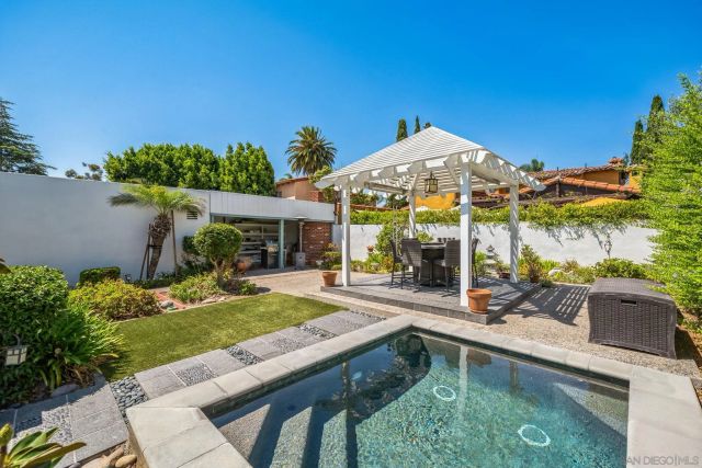a view of a house with backyard outdoor seating area and furniture