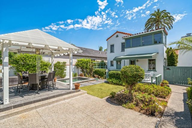 a view of a house with backyard porch and sitting area