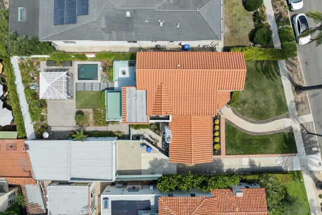 an aerial view of a house with a yard and potted plants
